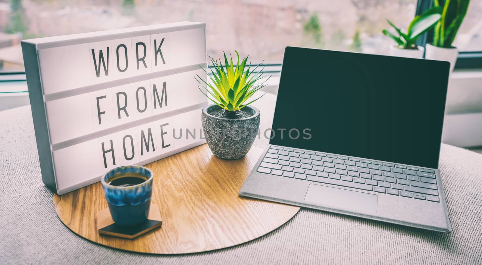 Working from home remote work inspirational social media lightbox message board next to laptop and coffee cup for COVID-19 quarantine closure of all businesses.