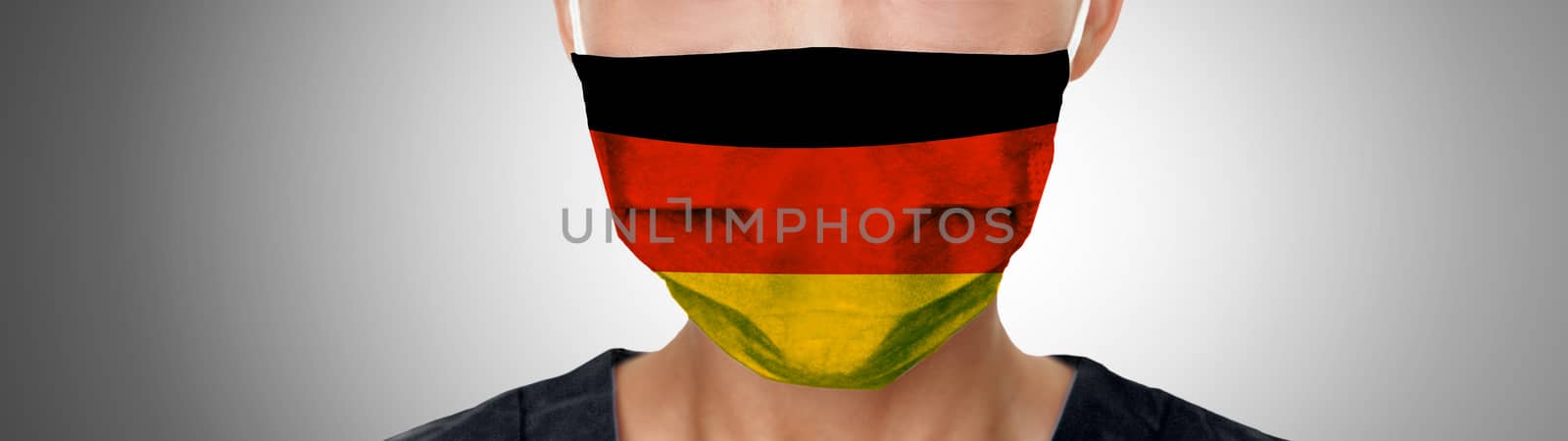 German COVID-19 masks flag on PPE doctor wearing mask panoramic banner. Coronavirus pandemic outbreak in Germany. Graphic design illustration print on medical personal protective equipment by Maridav