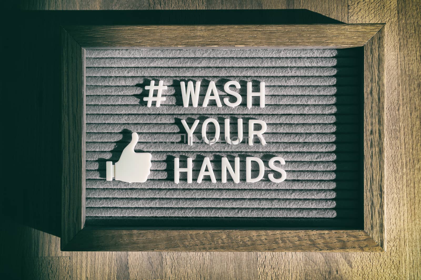 COVID-19 hand hygiene coronavirus message social media text for washing your hands hashtag. Corona virus felt board sign with letters WASH YOUR HANDS by Maridav