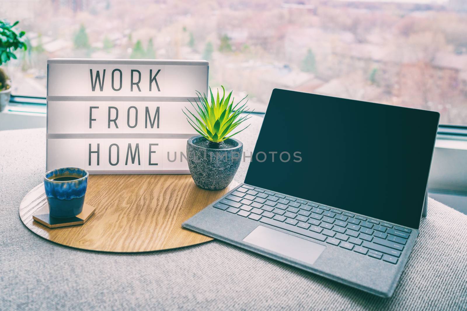 Working from home remote work inspirational social media lightbox message board next to laptop and coffee cup for COVID-19 quarantine closure of all businesses by Maridav