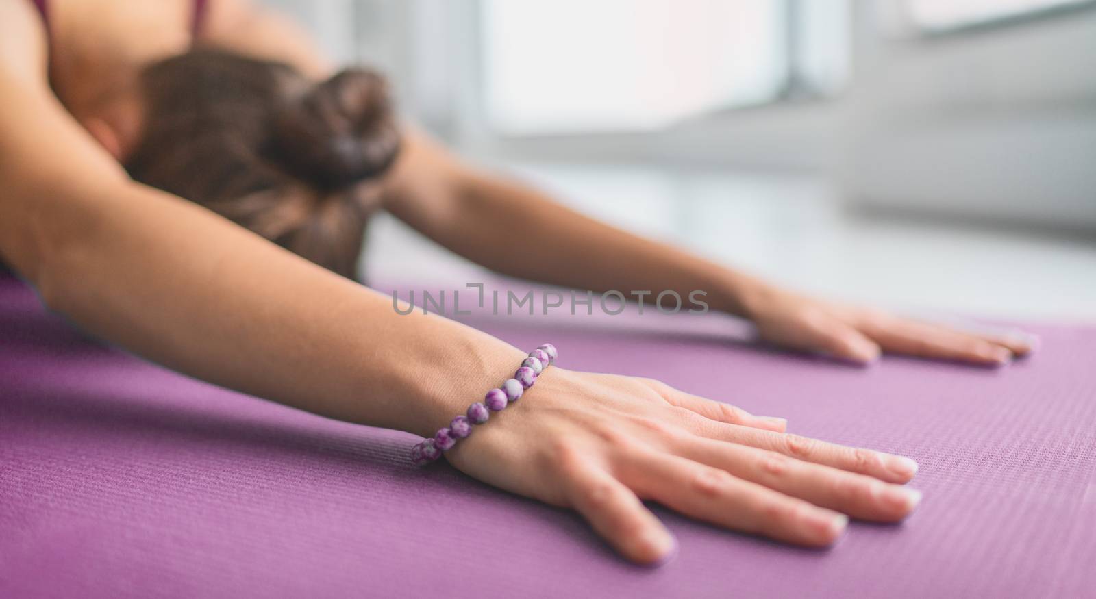 Yoga meditation at home on exercise mat stretching doing child's pose as warm up for calm mindfulness during stressful COVID-19 pandemic. Panoramic banner.