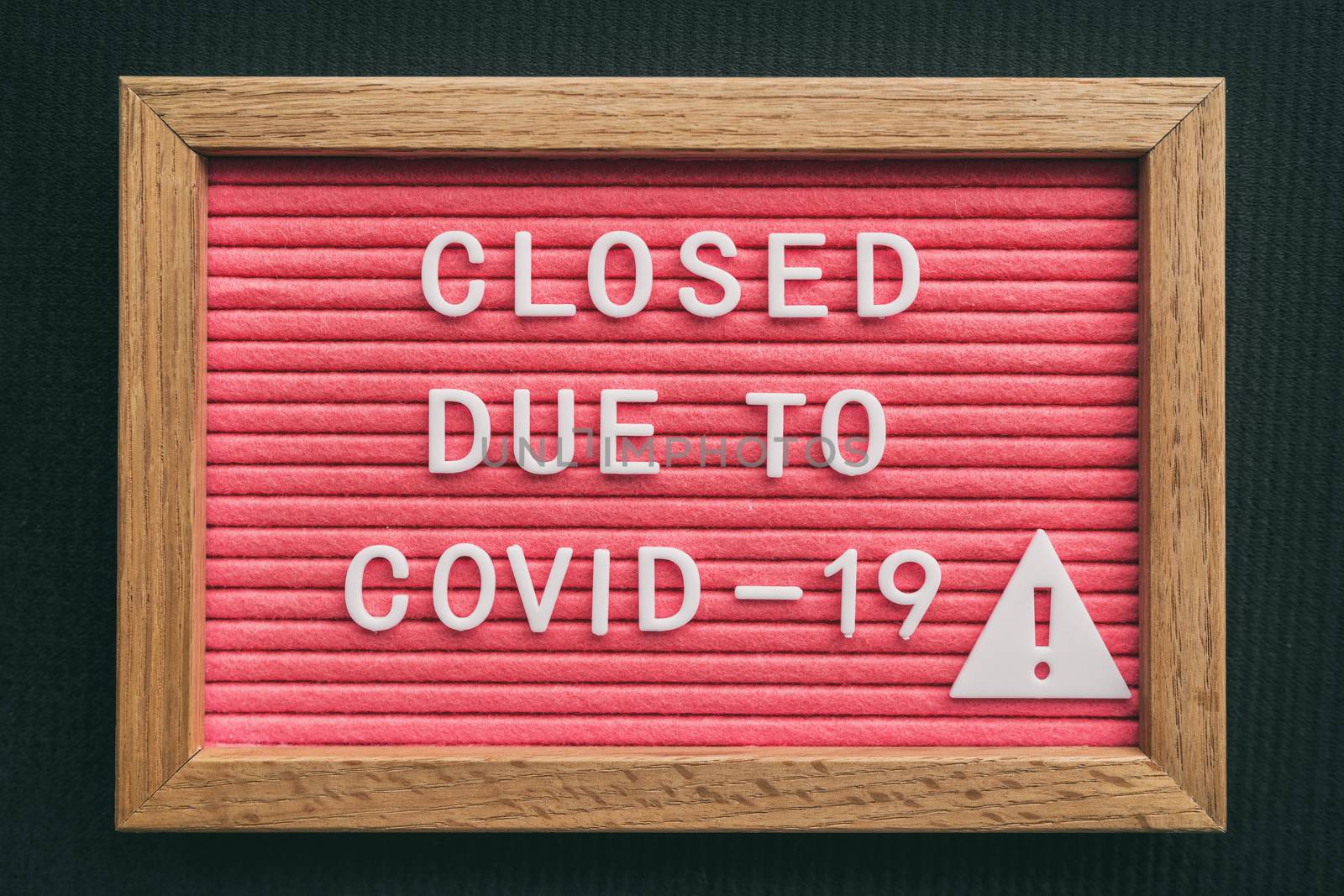 Coronavirus store closure sign. Closed due to COVID-19 message board for retail business COVID-19 pandemic outbreak. Government shutdown of restaurants, bakeries, non essential services. Pink letters.