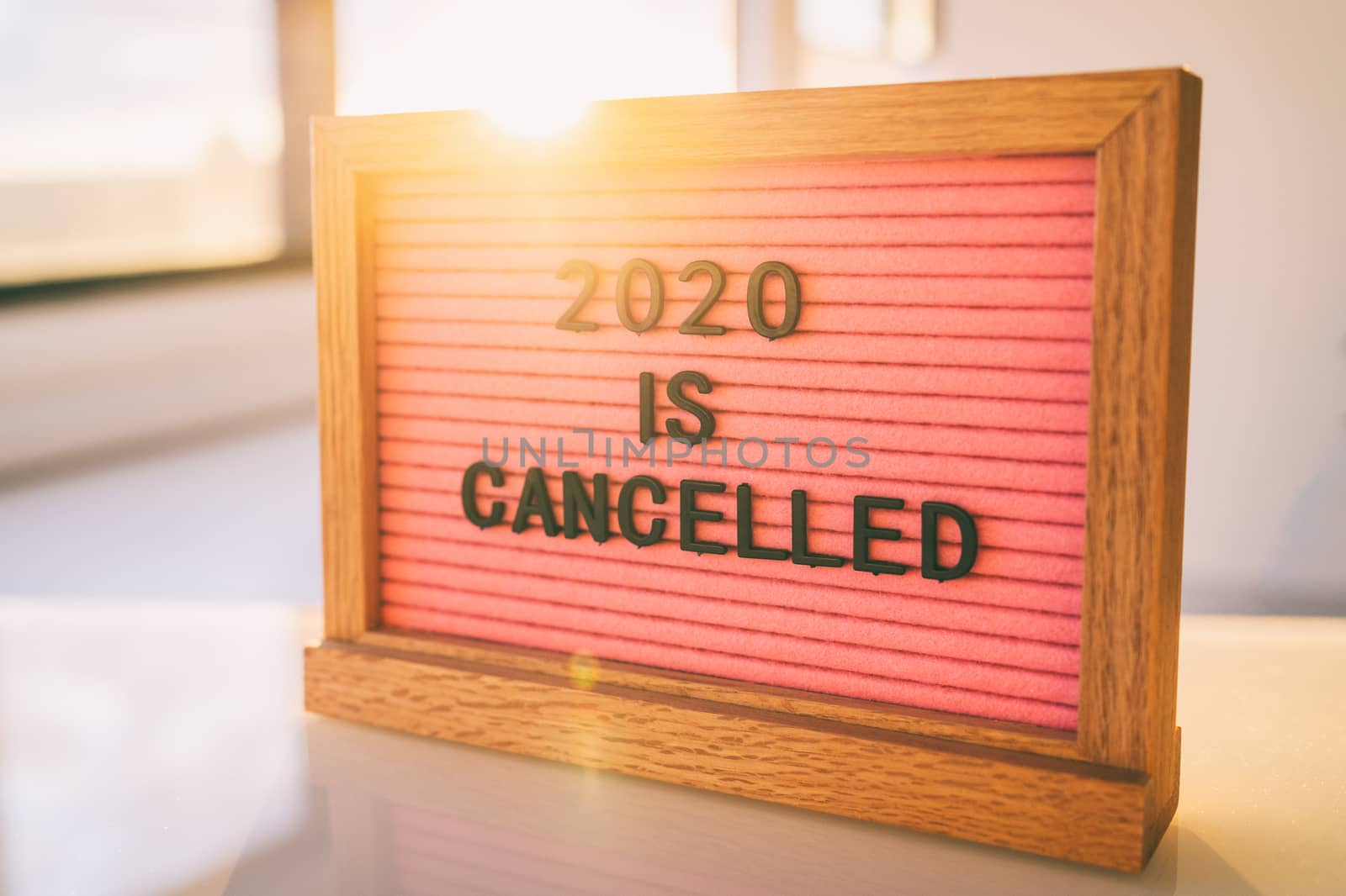 COVID-19 Funny Quote on pink felt sign board: 2020 IS CANCELLED message at home by Maridav