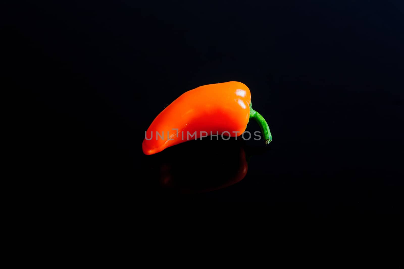 Small pepper on a black surface