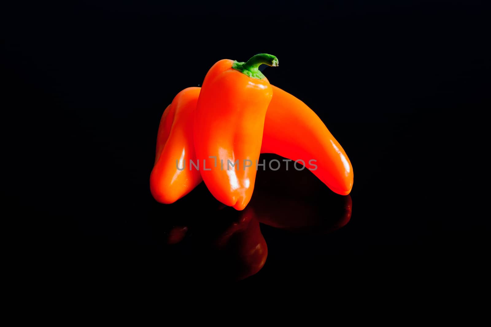 Small peppers on a black surface