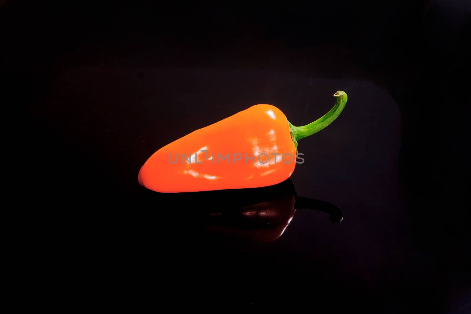 Small pepper on a black surface