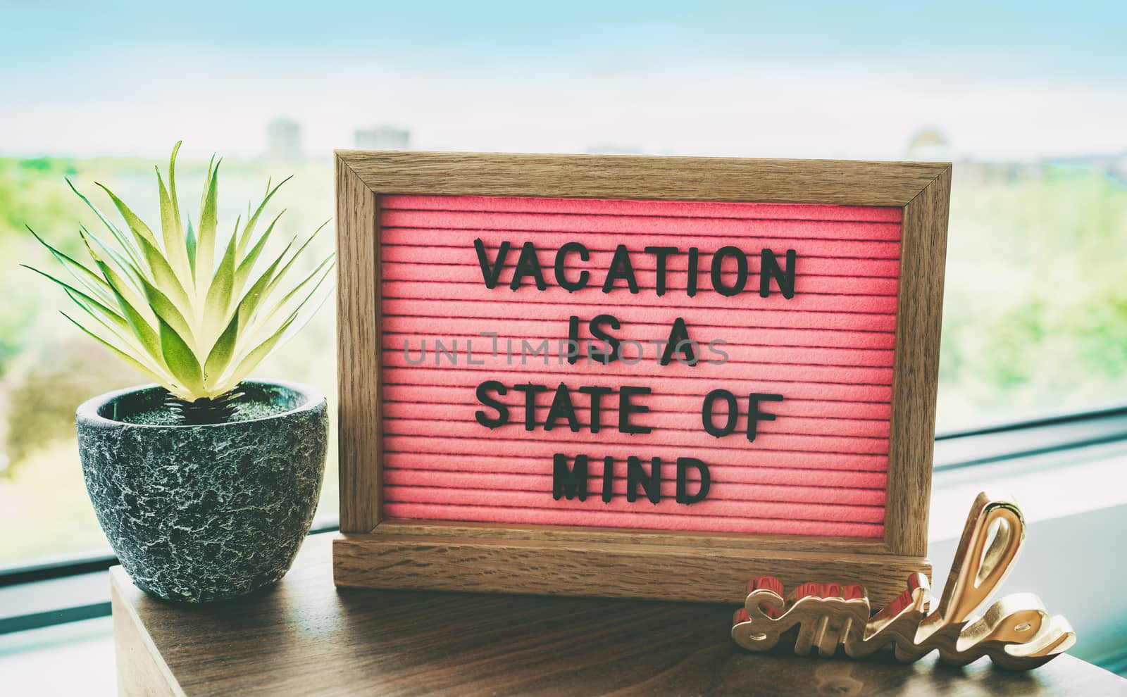 Vacation is a state of mind positive inspirational quote text on message board for summer holidays travel plans cancelled due to COVID-19 coronavirus. Staycation pink felt board text for staying home by Maridav