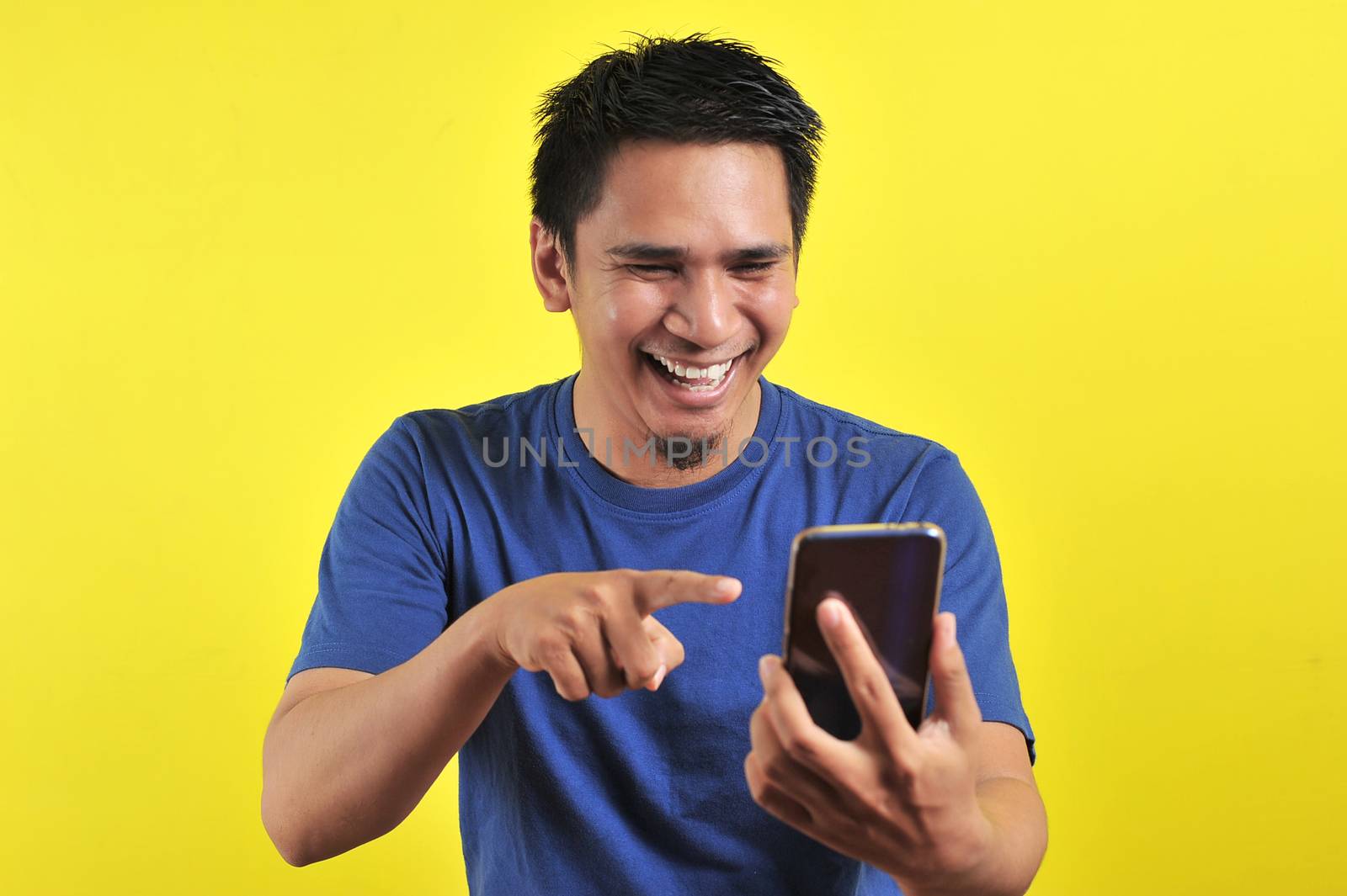 Happy of young good looking Asian man smiling using smartphone by heruan1507
