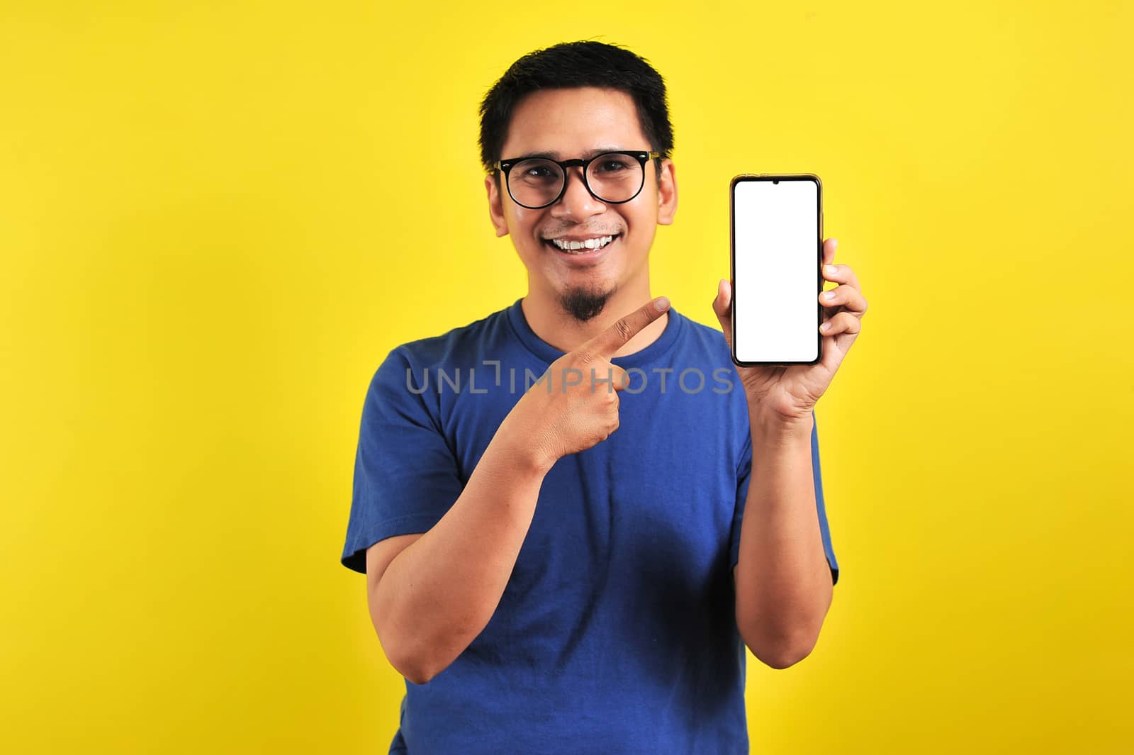 Happy Asian man showing a phone screen and pointing by heruan1507