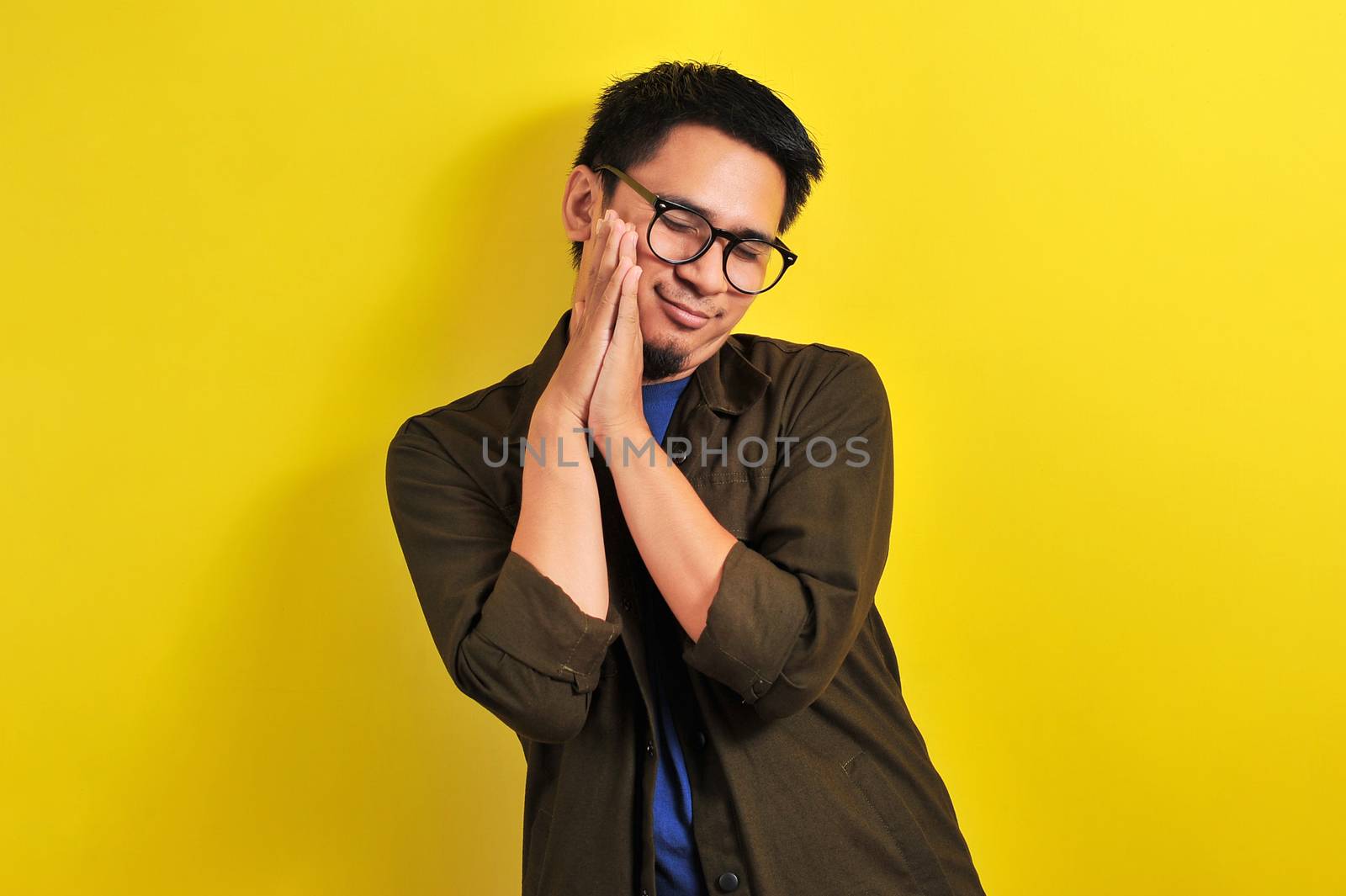 Asian man wear eyeglasses with sleep gesture by heruan1507