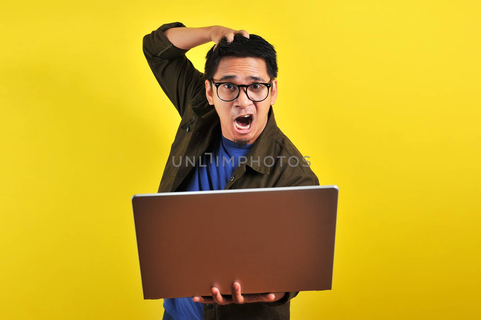 Asian online freelancer very angry in front of his laptop by heruan1507