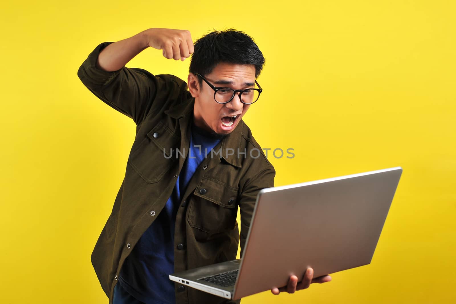 Asian online freelancer very angry in front of his laptop by heruan1507