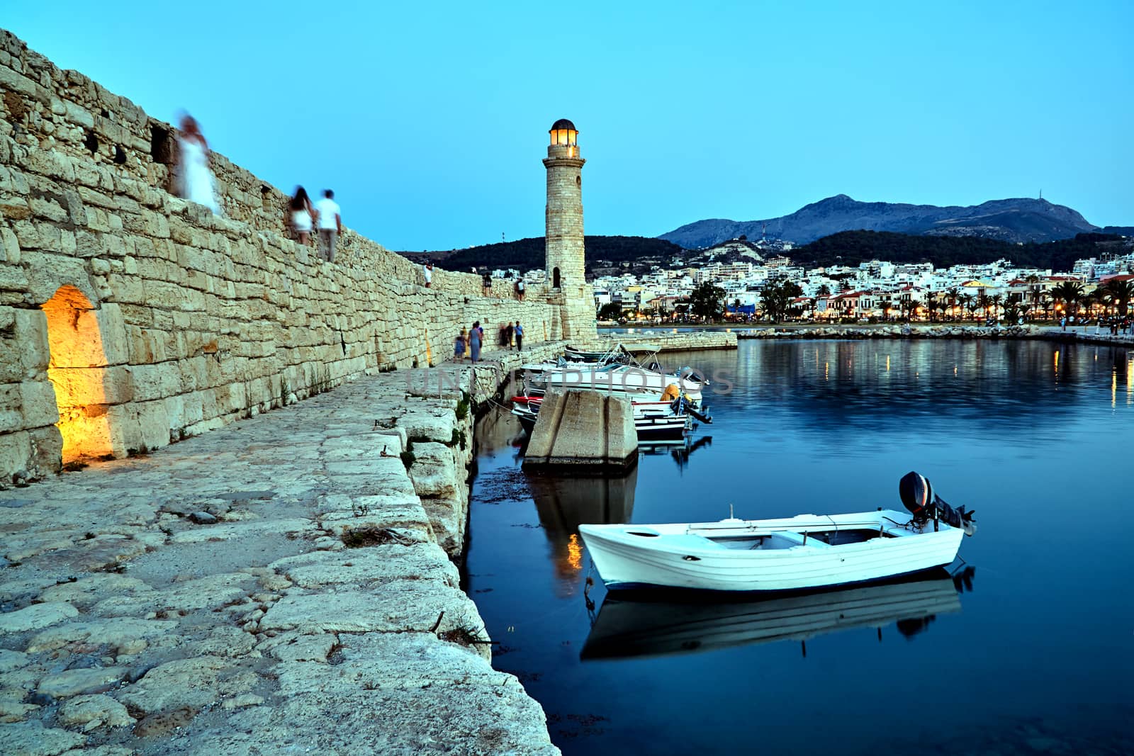 stone wall and historic lighthouse in the port of Rethymnon on the island of Crete