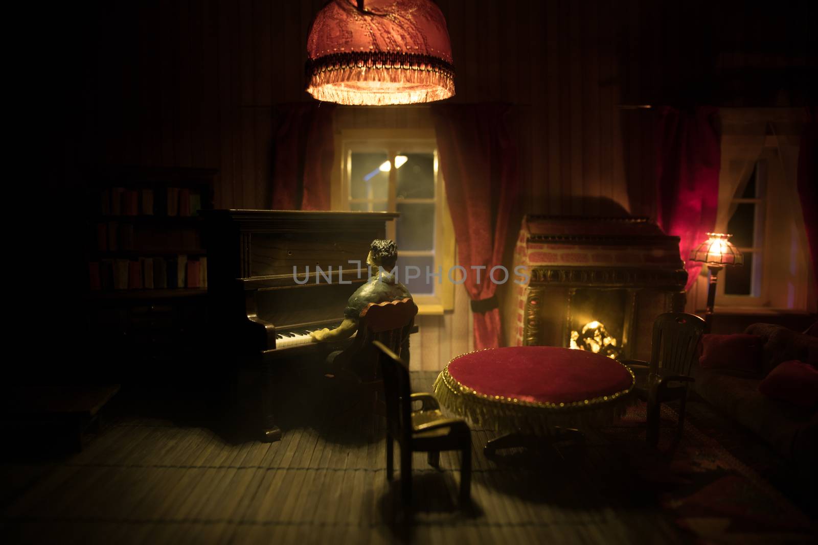 A realistic dollhouse living room with furniture and window at night. Man sitting at the old piano in dark room. Selective focus.