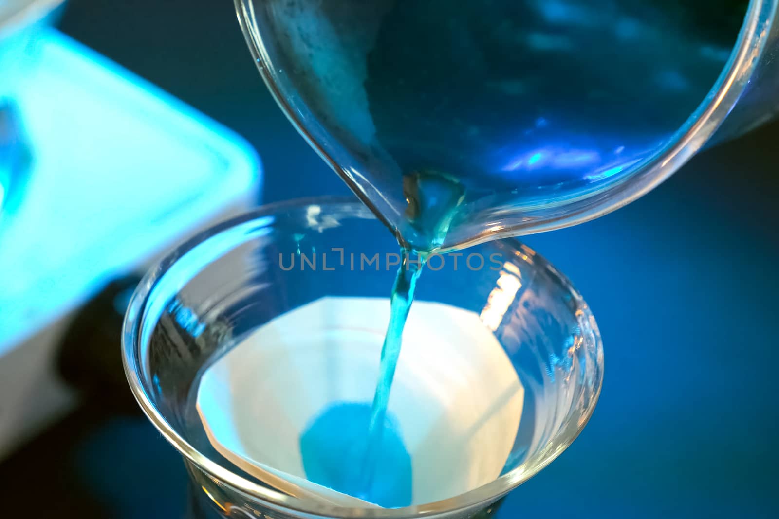 Chemical experiments. Pouring chemical agents into the flask.