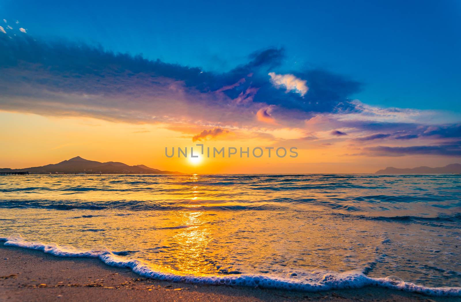 Idyllic evening twilight on the beach with soft sea water wave