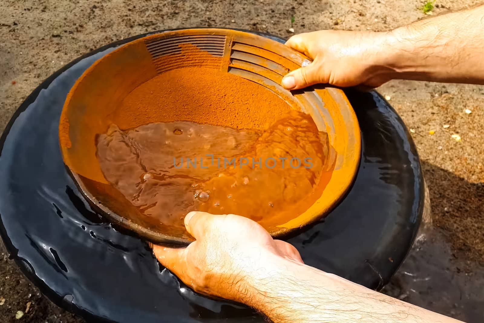 Gold mining, washing rock in search of gold.