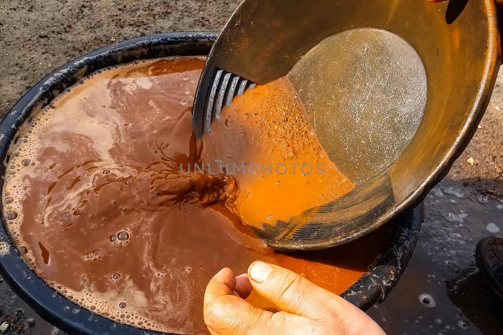 Gold mining, washing rock in search of gold.