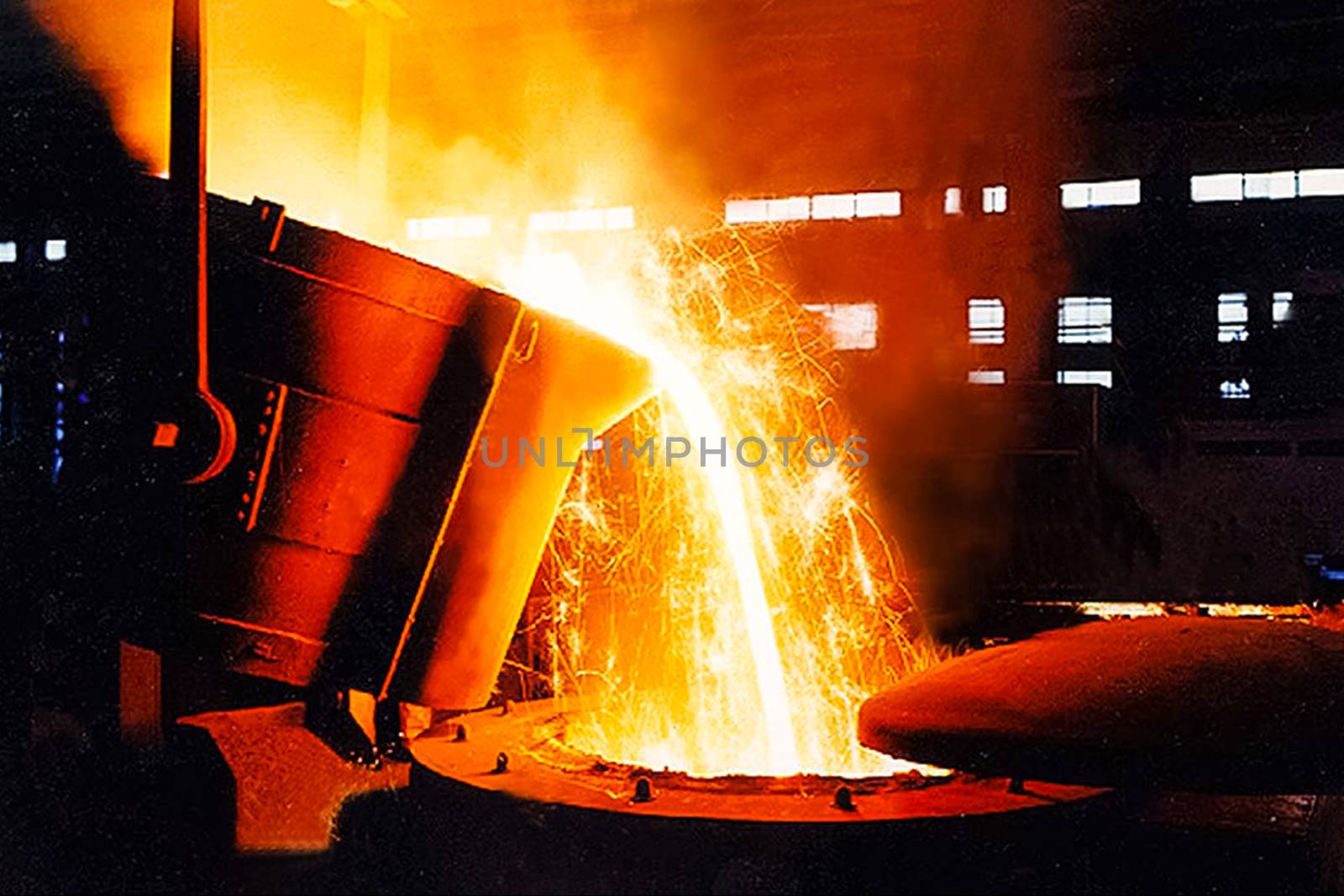 A large bowl of molten metal at a steel mill. Steel production.