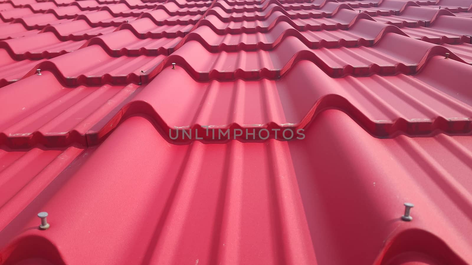 Closeup of red color roof tiles. Background texture for rooftop tiles.