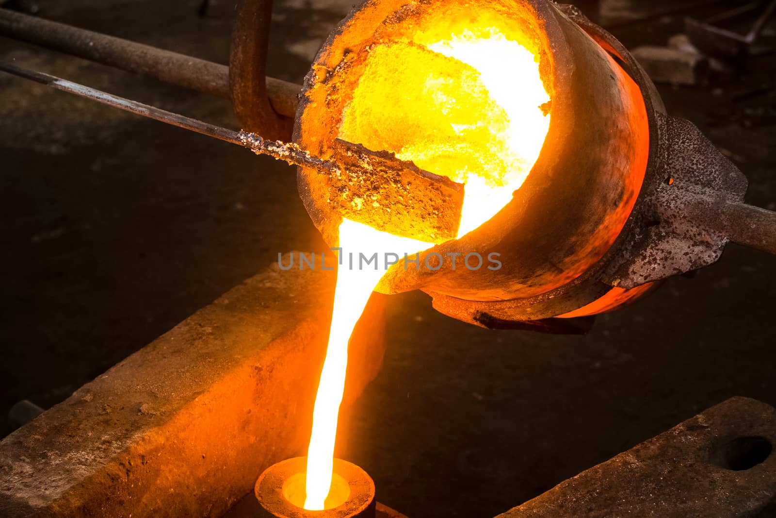 A large bowl of molten metal at a steel mill. Steel production.