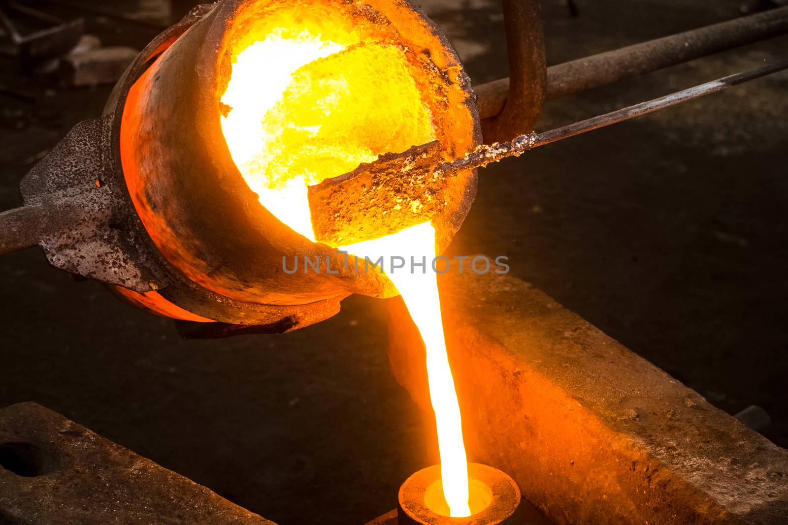 A large bowl of molten metal at a steel mill. Steel production.