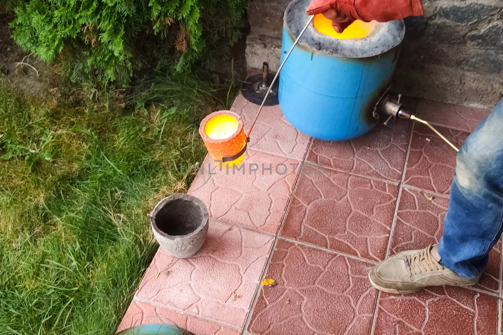 Melted metal in a fireproof cup taken from the oven. Melting copper at home.