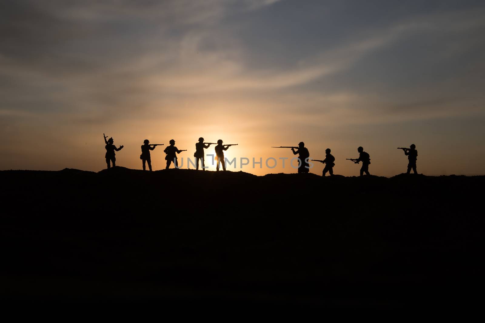 War Concept. Military silhouettes fighting scene on war fog sky background, World War Soldiers Silhouette Below Cloudy Skyline sunset. Selective focus