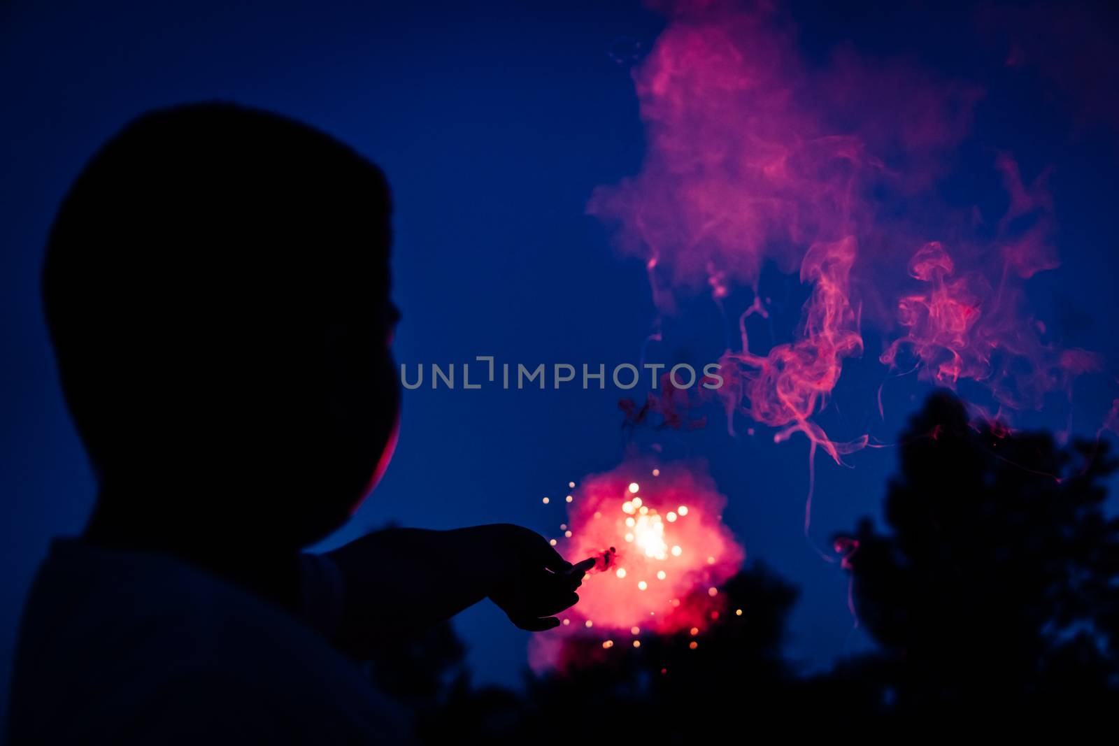 The boy is carrying firecrackers crackling in his hand