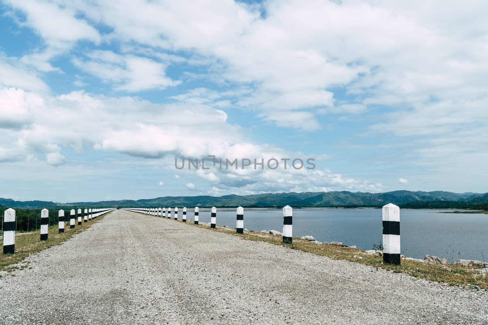 The road beside the reservoir surrounded by mountains