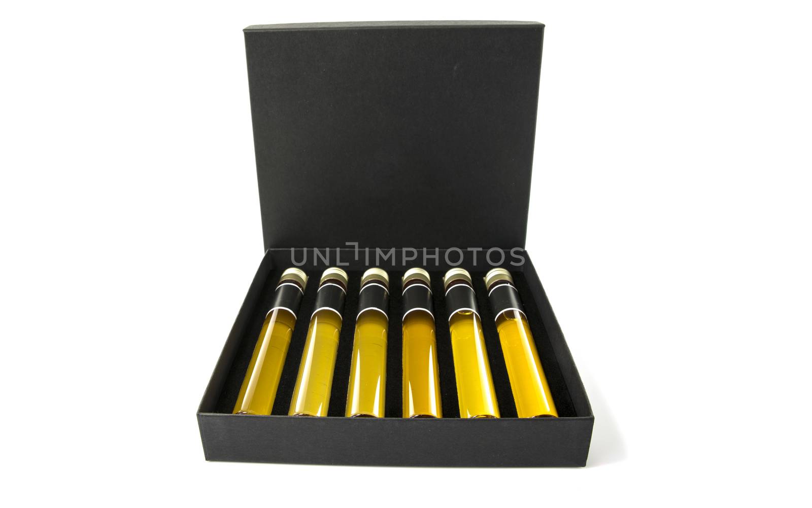 samples of six different whiskeys as a tasting collection on white background