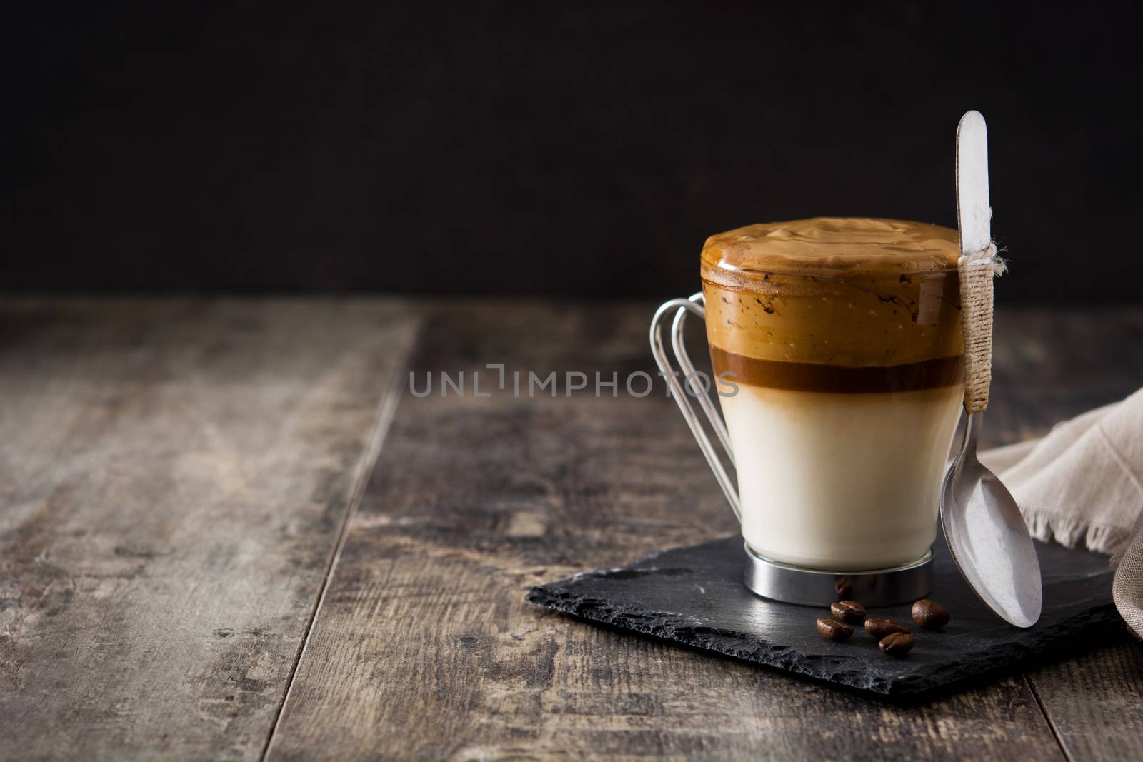 Creamy iced dalgona coffee on wooden table