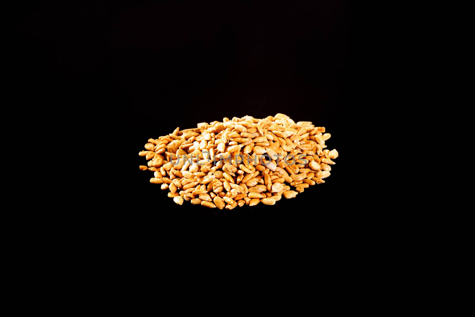 Roasted Salted Sunflower Seeds on a black background