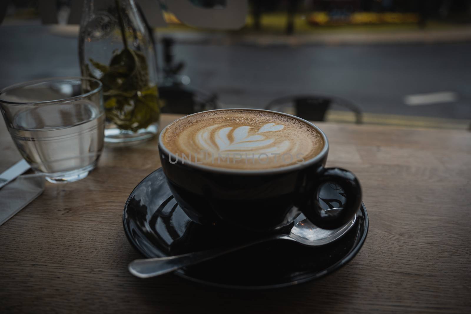 A close up of a cappuccino coffee at a cafe restaurant