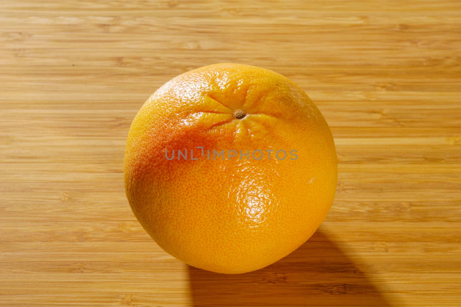 Red grapefruit on a wooden background