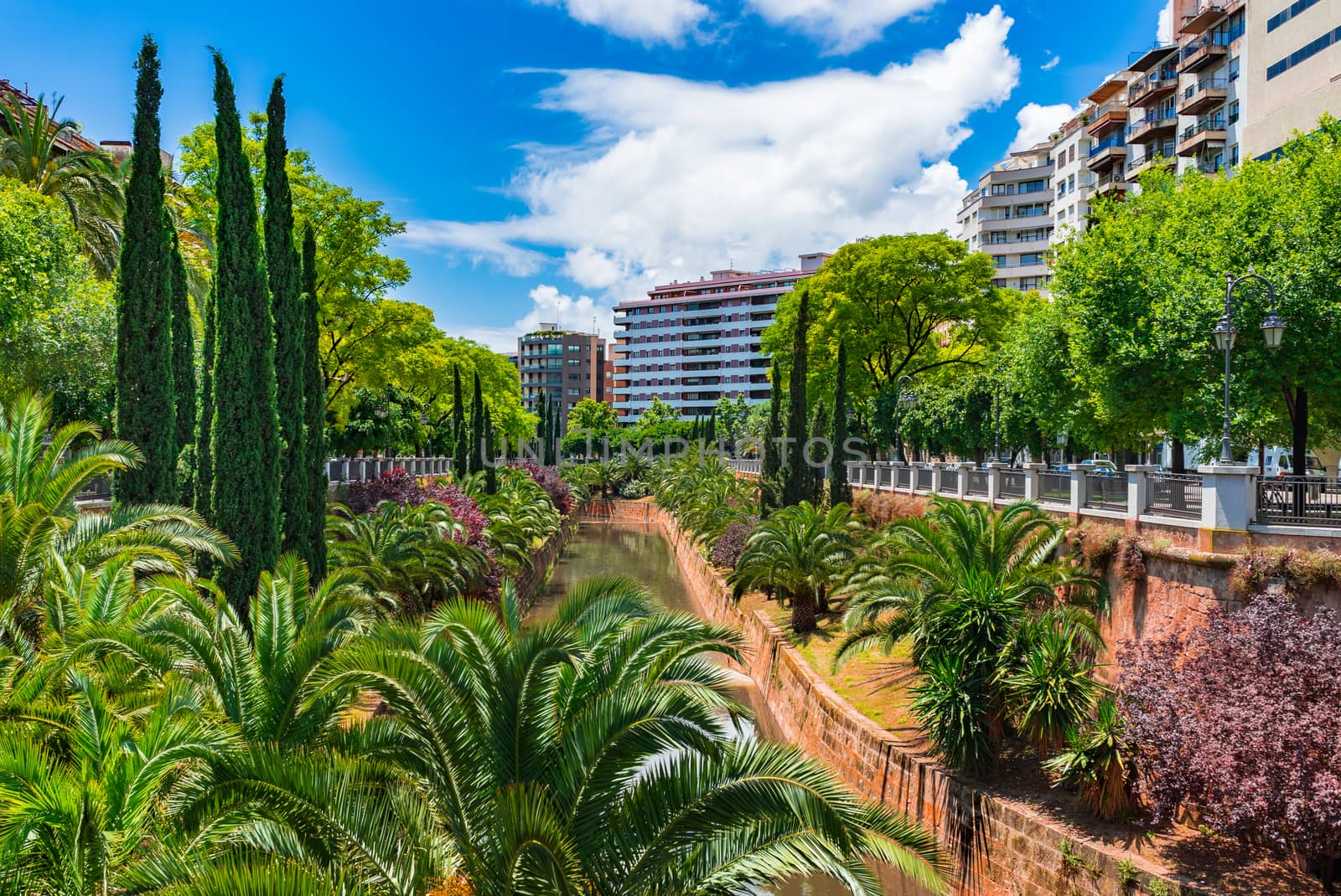 Citycape with water canal stream and park in Palma de Majorca, Spain