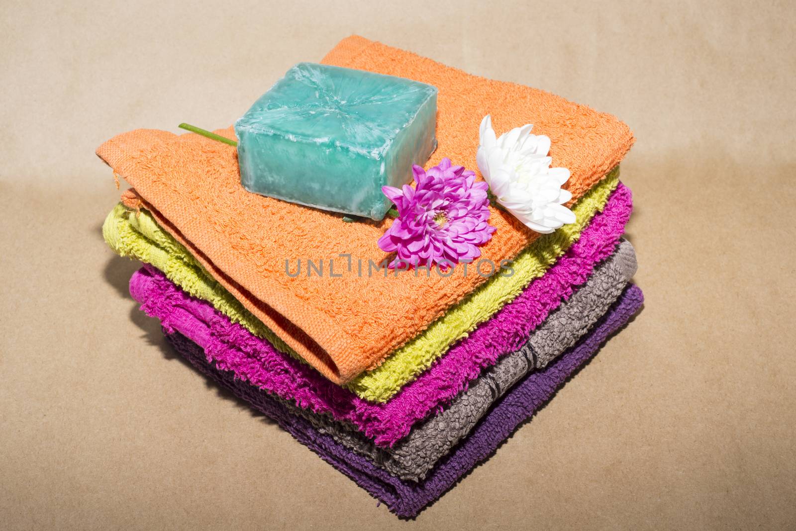soap bar on top of facecloths off various shades with flowers