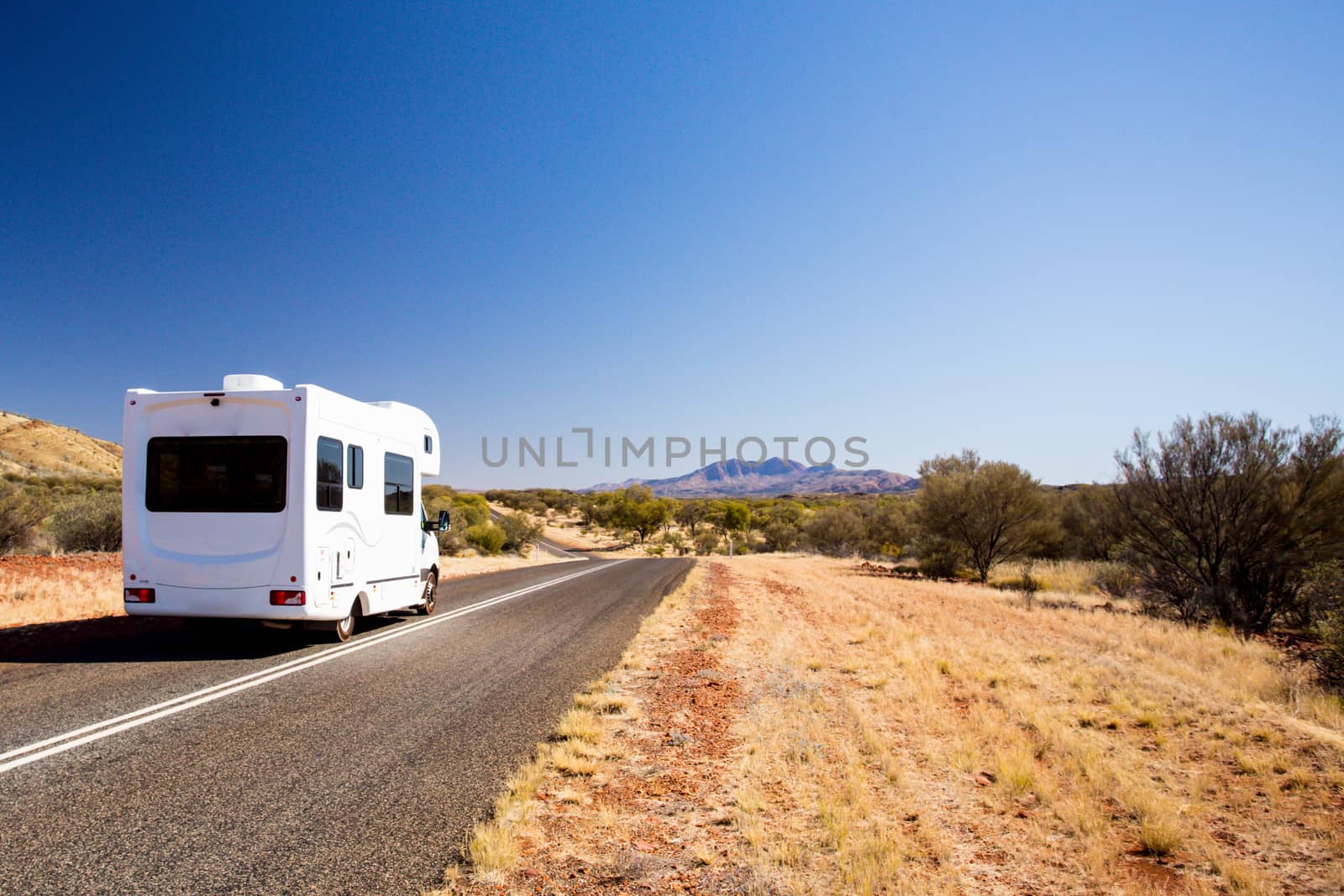 Campervan travelling on 1`Namatjira Drive near Mt Zeil in Northern Territory, Australia