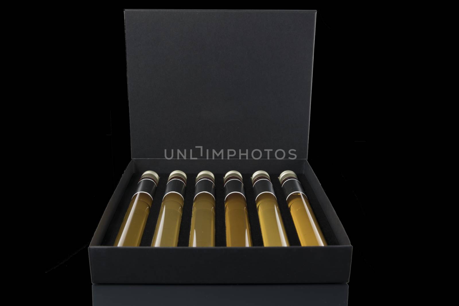 samples of six different whiskeys as a tasting collection on black background