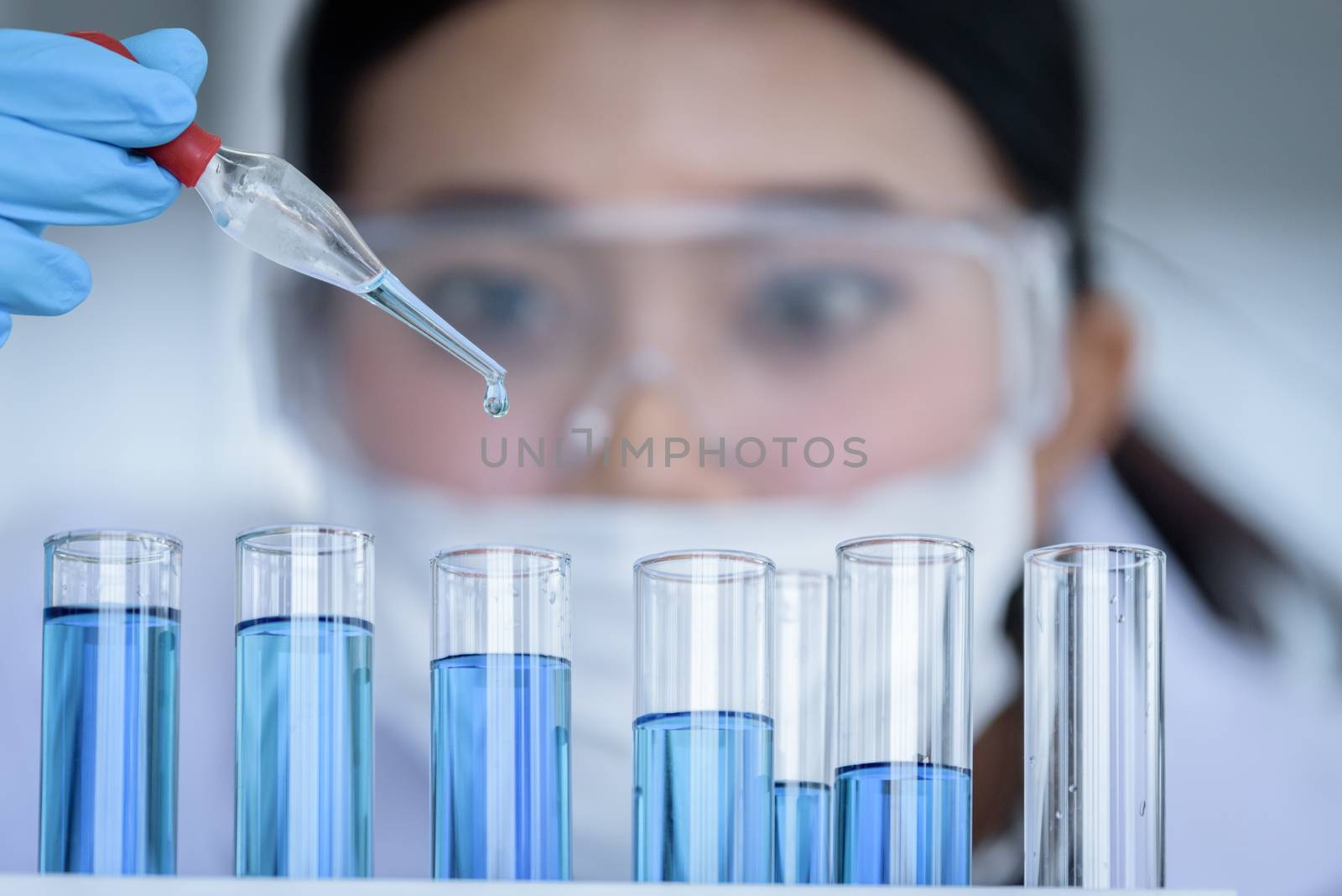 Asian young girl student scientist researching  and learning in a laboratory.