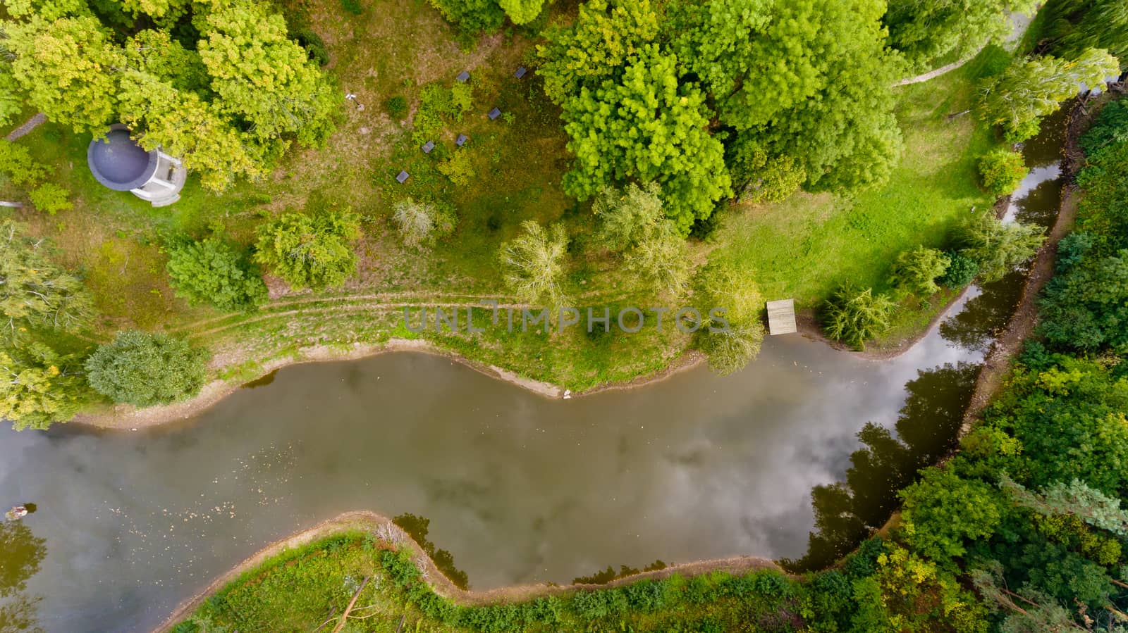 Top view of a small lake in a green forest. Aerial view.