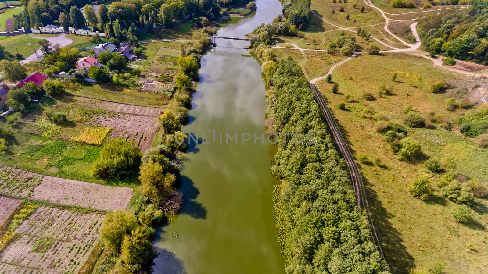 Beautiful view of the forest and the river in the city. Aerial view.