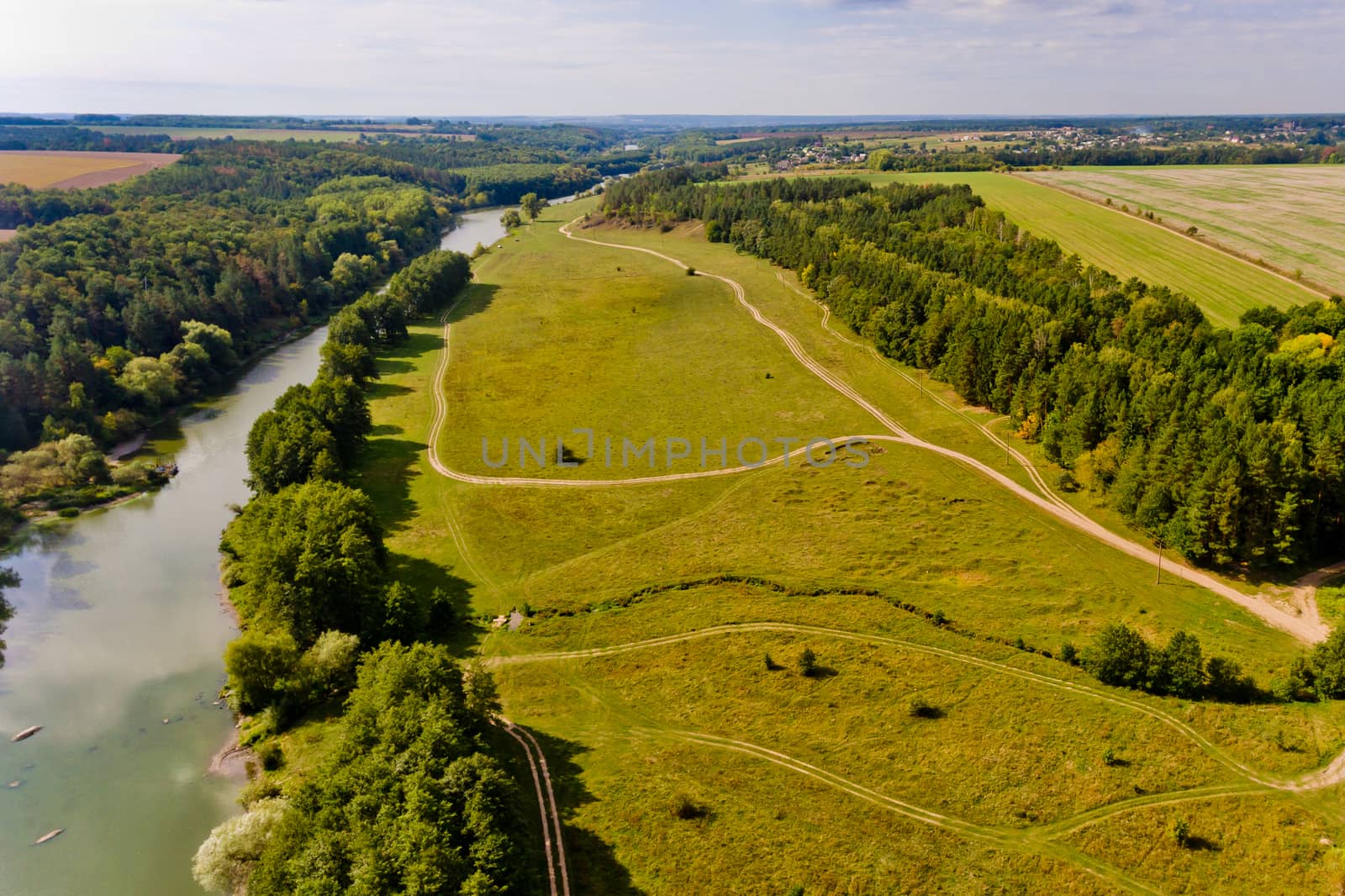 Beautiful view of the forest and the river in the city. Aerial view.