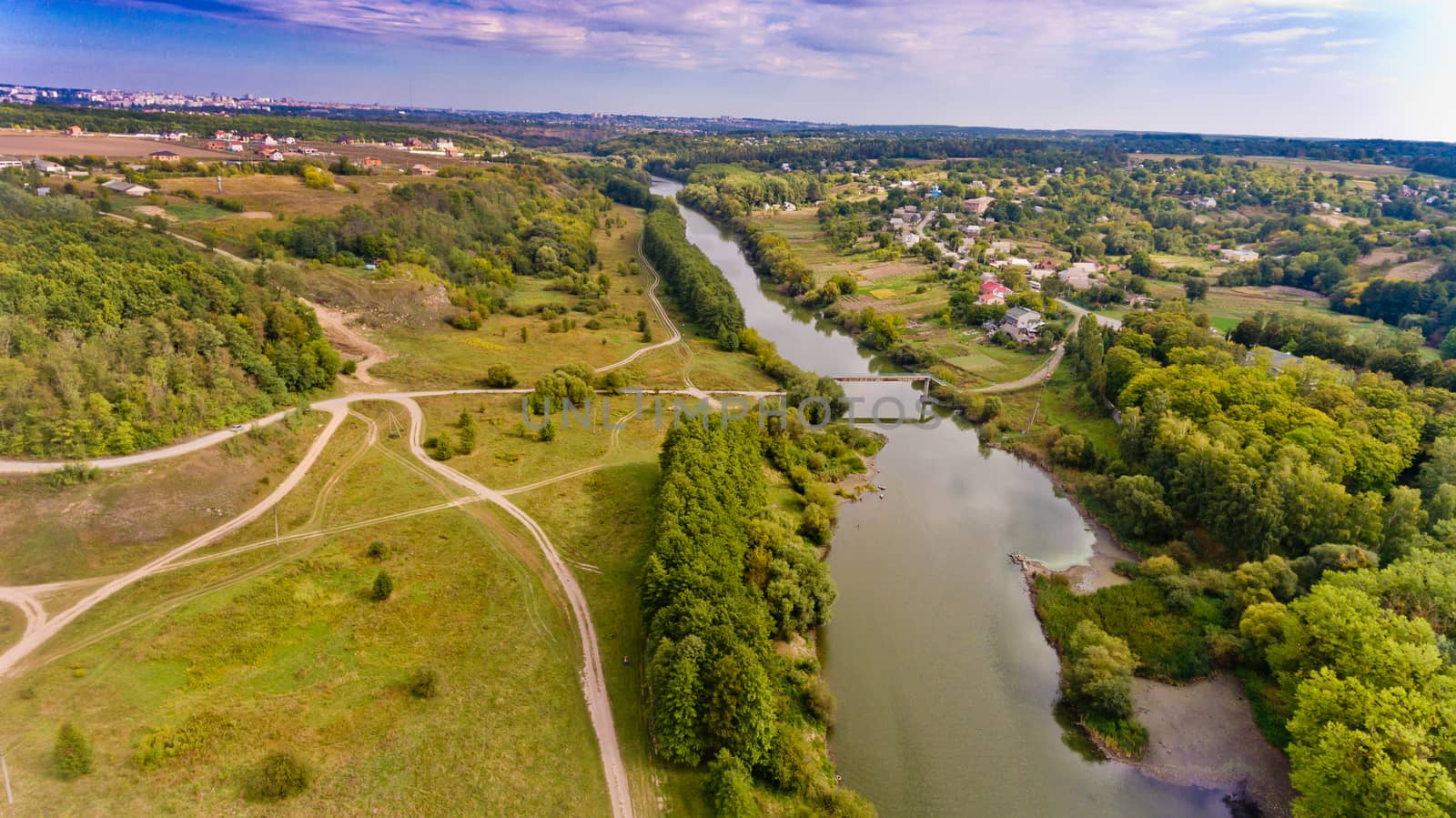 Beautiful view of the forest and the river in the city. Aerial view. by leonik