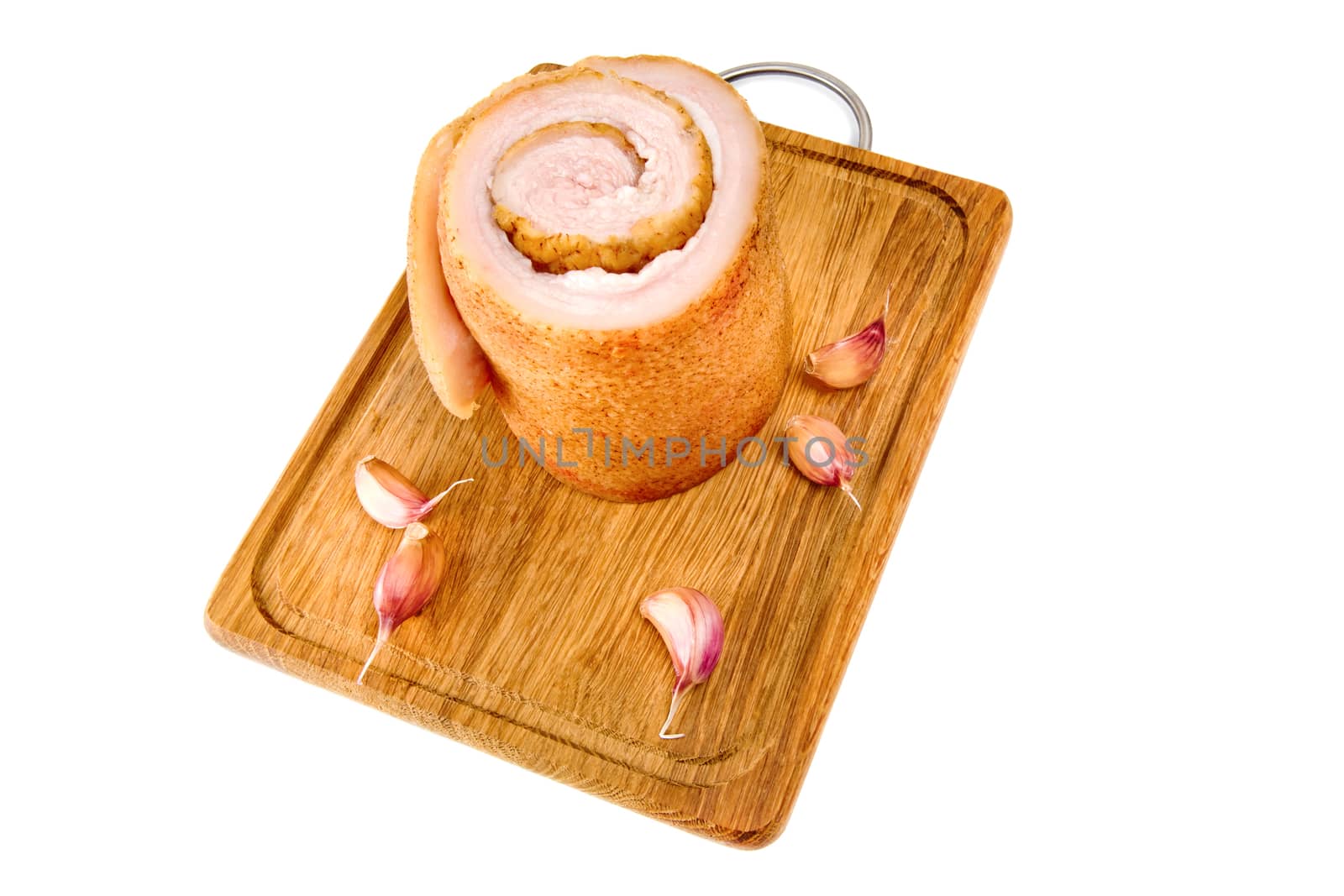 Pork belly and not peeled garlic on wooden board isolated on a white background.