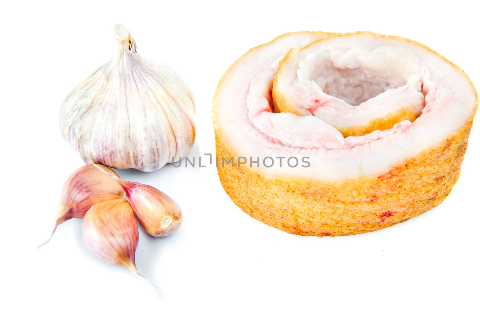 Pork belly with garlic isolated on a white background.