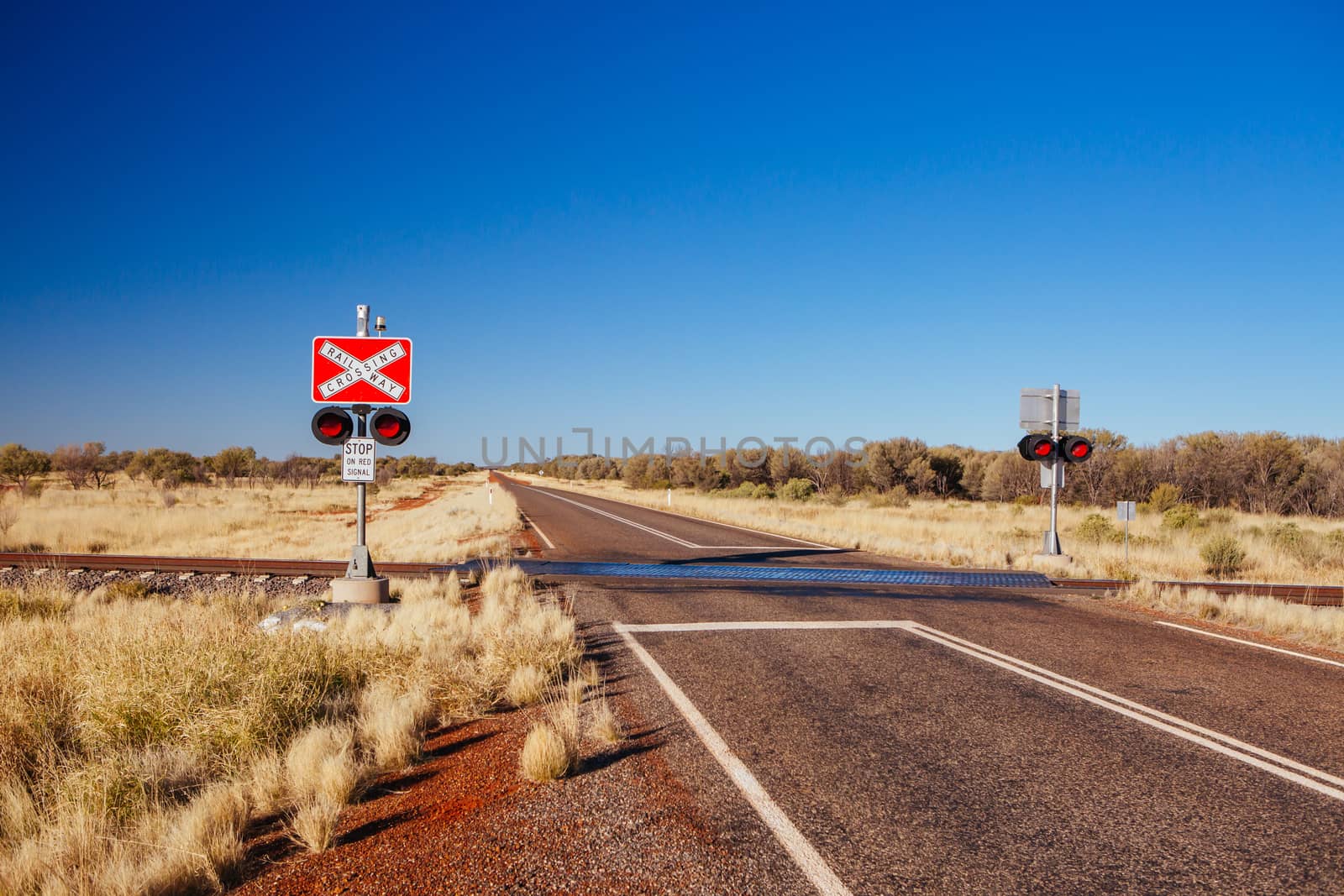 The famous Ghan railway track and crossing with warnings near Alice Springs extends all the way to Darwin in Northern Territory, Australia