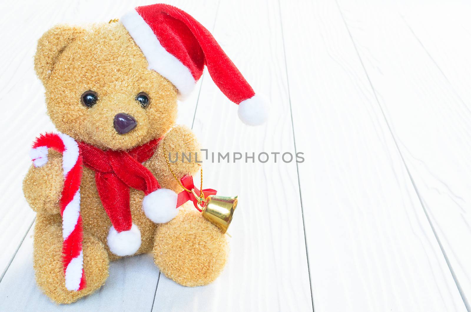 A Santa Bear Doll has already to celebrate the christmas and new year festival with wood background.