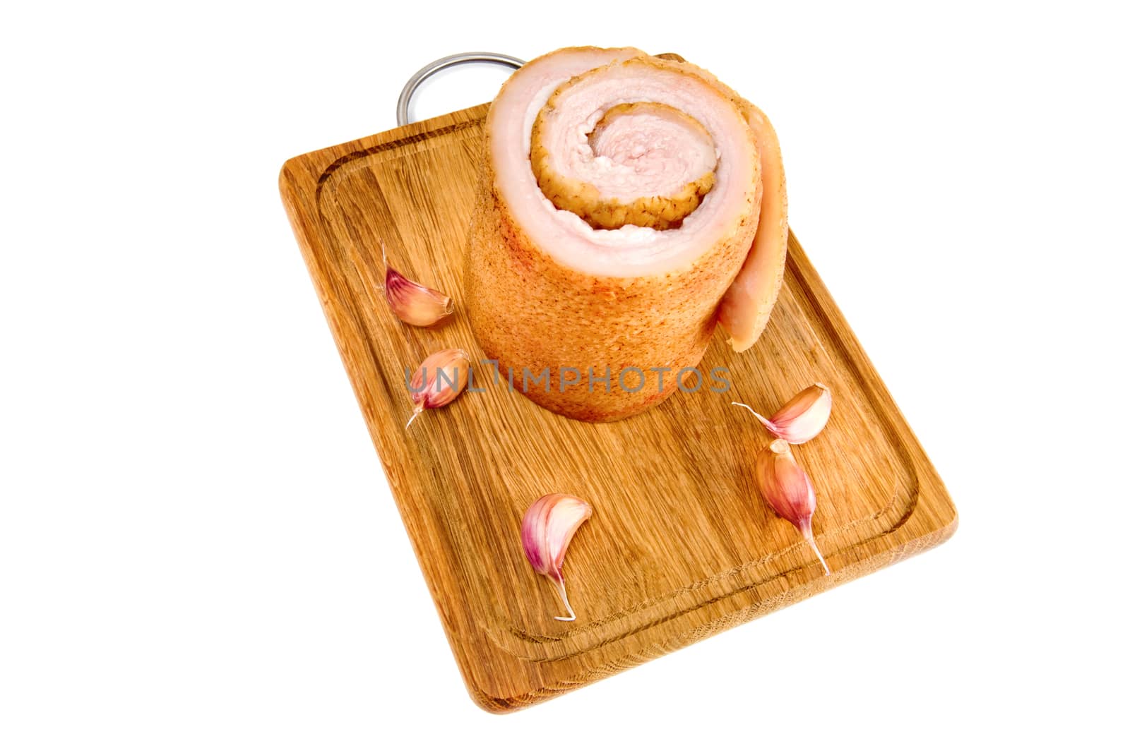 Pork belly and not peeled garlic on wooden board isolated on a white background.