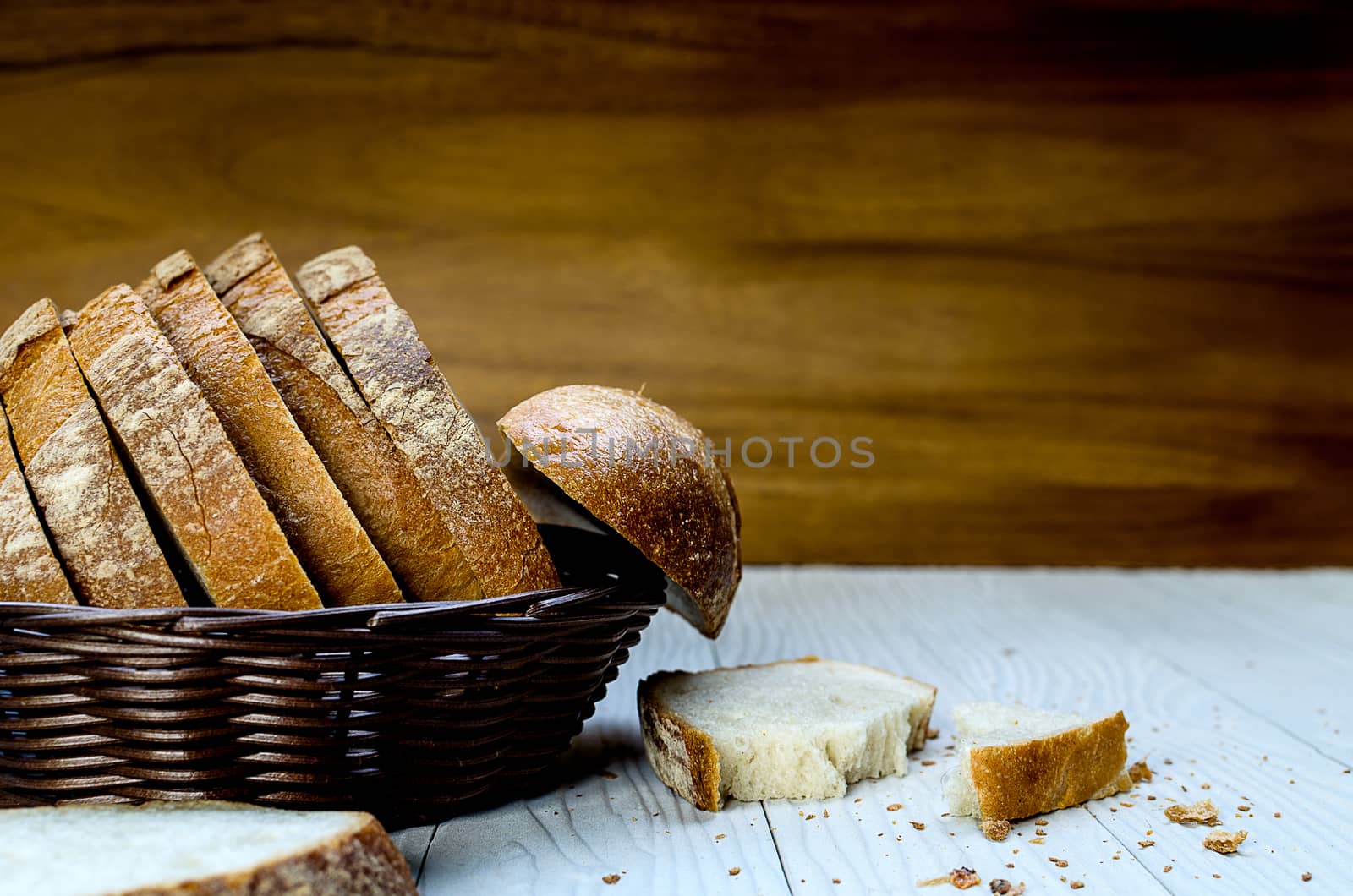 A Sliced Pain De Campagne Au Levain Bread in the wicker brown wood basket bowl.